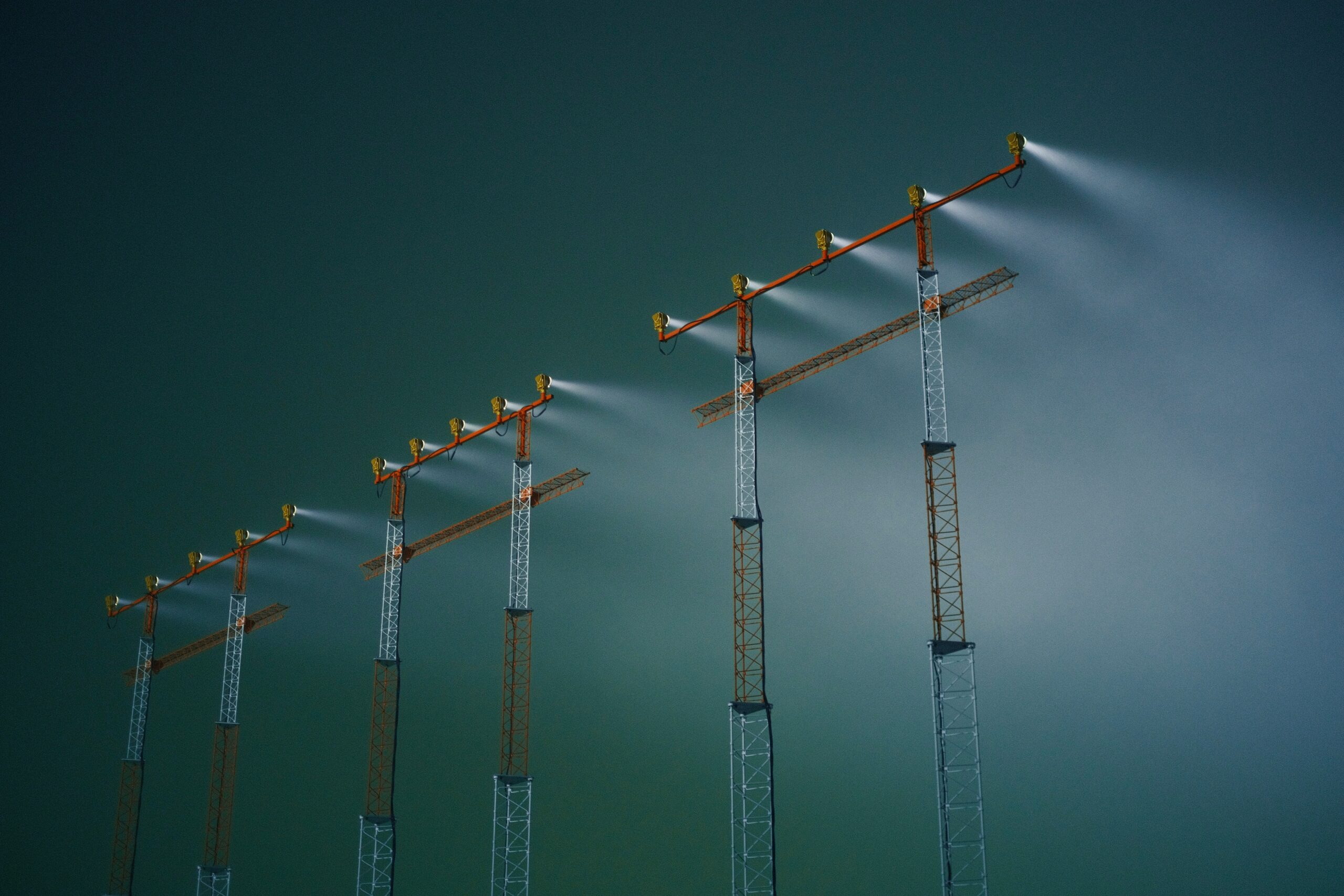 A row of poles with a sky background